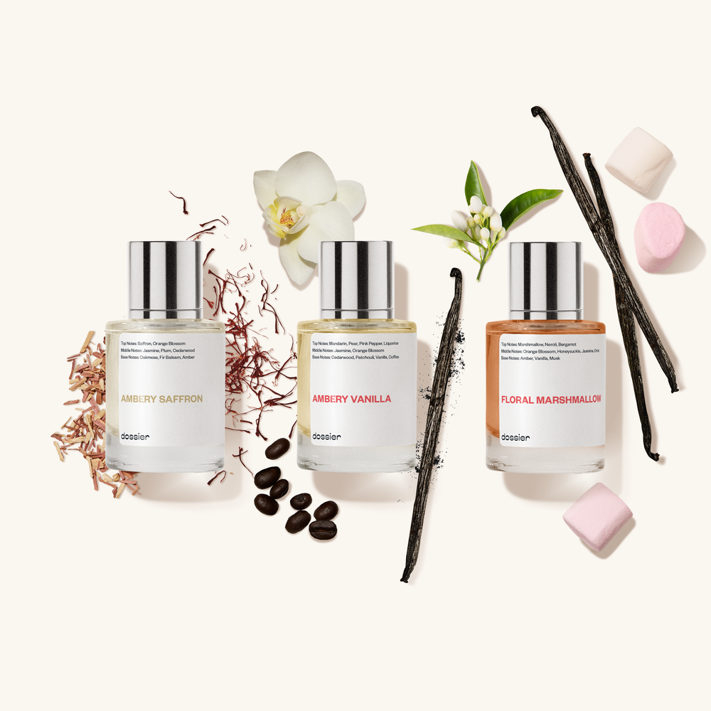Three perfume bottles with floral and vanilla elements on a white background